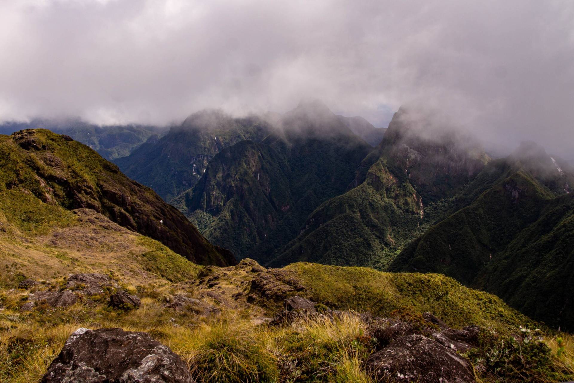 Image of steep mountains shrouded in fog.